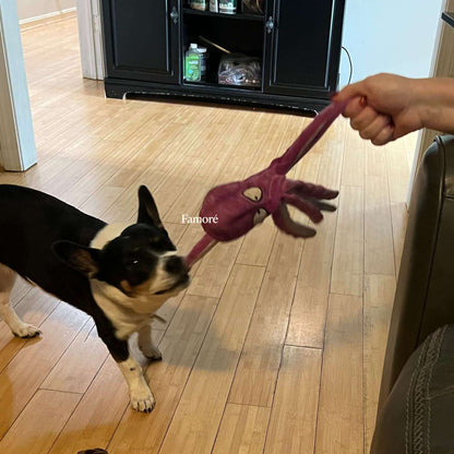 Dog playing with a purple toy on a wooden floor